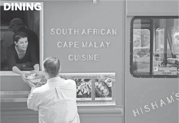  ?? JOSHUA A. BICKEL ?? Four years ago, Hisham Omardien and his wife, Olivia Clark, started Hisham’s Food Truck, which specialize­s in Cape Malay South African cuisine. The couple were dancers with Balletmet before opening the business.
