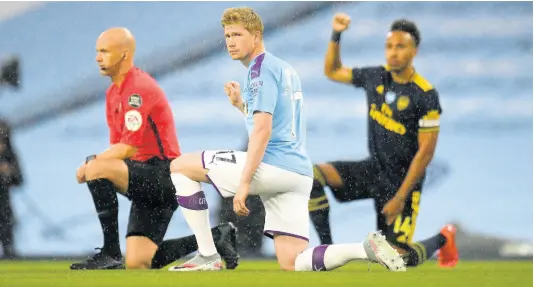  ?? AP ?? Manchester City’s Kevin De Bruyne (centre) takes a knee in support of the Black Lives Matter movement before the English Premier League match between Manchester City and Arsenal at the Etihad Stadium in Manchester, England, on Wednesday, June 17.