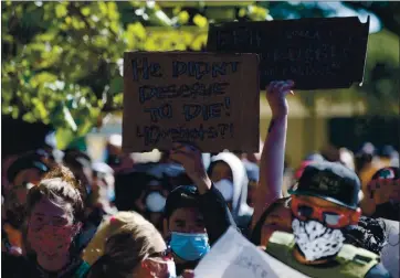  ?? PHOTO BY JANE TYSKA — BAY AREA NEWS GROUP ?? Protesters march along 98th Avenue in support of Erik Salgado in Oakland on June 8. Salgado, 23, was shot and killed on June 6 by California Highway Patrol (CHP) officers and his pregnant girlfriend was wounded.