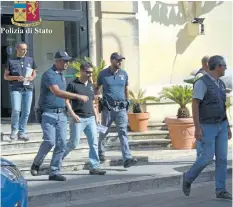  ?? THE ASSOCIATED PRESS ?? An handout photo by the Italian State Police press office of Ragusa shows the arrest of one of fifteen firefighte­rs in Sicily who are suspected of having set fires or having friends or family call in false alarms so they could be called to work.