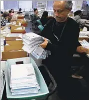  ?? Patrick T. Fallon For The Times ?? ABSENTEE ballots are sorted at the L.A. County Registrar-Recorder/County Clerk’s office Nov. 7.