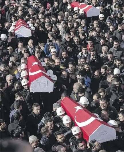  ?? DAGHAN KOZANOGLU / GETTY IMAGES ?? Mourners carry flag- draped coffins in Istanbul, Turkey, on Sunday. At least 38 people were killed and 155 wounded in twin bombings outside a stadium, the Vodafone Arena, on Saturday night.