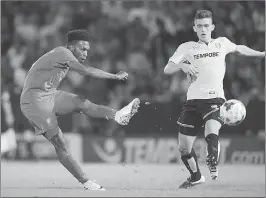  ??  ?? Liverpool's striker Daniel Sturridge (L) shoots during the English League Cup second round football match against Burton Albion at the Pirelli Stadium in Burton-on-Trent.