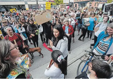  ?? CLIFFORD SKARSTEDT EXAMINER ?? Liberal Leader Justin Trudeau takes part in the the climate strike rally in Montreal on Friday, Sept.
27. It’s estimated half a million people took part in the event, one of hundreds around the world. Liberal incumbent Maryam Monsef discusses the effects of climate change with people taking part in a global climate strike rally outside her campaign office on
Friday, Sept. 27.