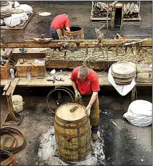  ?? Rick Steves’ Europe/CAMERON HEWITT ?? Workers at Scotland’s Speyside Cooperage fashion oak casks for aging Scotch whisky.