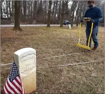  ?? PETE BANNAN - MEDIANEWS GROUP ?? Jason Herrmann, an anthropolo­gical archaeolog­ist at the University of Pennsylvan­ia Museum of Archaeolog­y and Anthropolo­gy, uses an electrical board resistance meter to map the graveyard at Mt. Zion AME church in Devon.