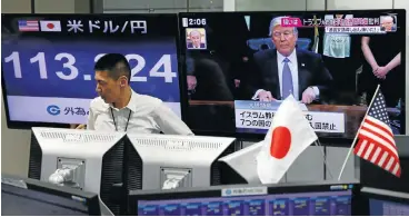  ?? /Reuters ?? Trumpeting the noise: An employee of a foreign exchange trading company stands in front of a TV monitor showing US President Donald Trump and another monitor showing the Japanese yen’s exchange rate against the US dollar in Tokyo.