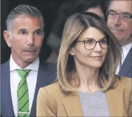  ?? STEVEN SENNE — THE ASSOCIATED PRESS ?? Clothing designer Mossimo Giannulli, left, and actress Lori Loughlin depart federal court in Boston last year after a hearing in the nationwide college admissions bribery case.