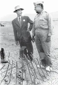  ?? COURTESY OF LOS ALAMOS NATIONAL LABORATORY ?? J. Robert Oppenheime­r, director of the science team at Los Alamos, and Maj. Gen. Leslie R. Groves, director of the Manhattan Project, visit Trinity Site in September 1945, two months after the atomic bomb test there. They are standing next to what’s left of the 100-foot steel tower on which the bomb was detonated.