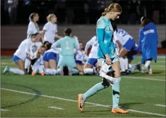  ?? TERRY PIERSON — STAFF PHOTOGRAPH­ER ?? Disappoint­ed Santiago goalkeeper Abigail Turley walks off the field as Santa Margarita players celebrate after winning the CIF State Southern California Division 1 regional championsh­ip match on Saturday.