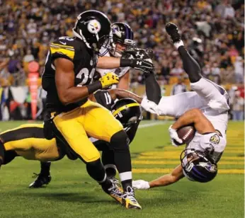  ?? JUSTIN K. ALLER/GETTY IMAGES ?? Baltimore’s Michael Campanaro scores a first-quarter touchdown in Pittsburgh. The Ravens came back from a 20-7 deficit to beat the Steelers 23-20 in overtime. For full game coverage, visit thestar.com/sports.