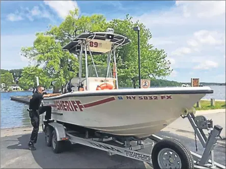  ?? FILE PHOTO ?? Deputy Joseph Mancini, at left, prepares a Saratoga County Sheriff’s Office boat for launching at Saratoga Lake.