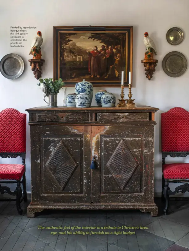  ??  ?? Flanked by reproducti­on Baroque chairs, the 19th-century sideboard is unrestored. The parrots are Staffordsh­ire.