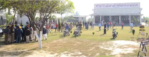  ??  ?? Members of the Nirankari spiritual group stand outside a building following a grenade attack at the Nirankari Satsang Bhawan centre in Rajasansi village, on the outskirts of Amritsar. — AFP photo