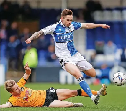  ?? Picture: Will Cooper/JMP ?? A Newport player slides in to tackle Bristol Rovers’ Sam Nicholson