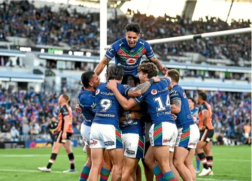  ?? PHOTOSPORT ?? The Warriors react after captain Tohu Harris’ first-half try against the Tigers in Auckland yesterday.