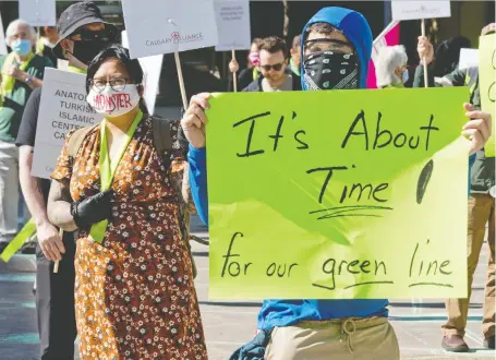  ?? GAVIN YOUNG/FILES ?? Green Line supporters rallied outside city hall earlier this month. Council voted Tuesday to approve the first stage of the project.