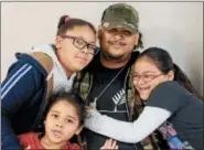  ??  ?? Veteran Carlos Luciano Jr. surrounded by his children Carlos Luciano III, 5, front; (left) Gianni Luciano, 11, left, and Samanni Luciano, 7. Luciano comes to the Hope Rescue Mission primarily for the camaraderi­e of his fellow veterans. He attended the...