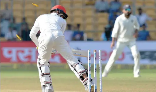  ?? AFP ?? Afghanista­n batsman Mohammad Yamin Ahmadzai is bowled by Ishant Sharma during the second innings of the one-off Test match against India. —