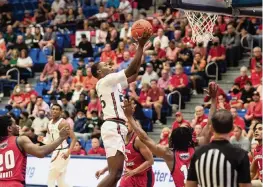  ?? TESSA MORTENSEN Miami Athletics ?? UM freshman Wooga Poplar drives to the basket for two of his 12 points as the Hurricanes eked out a two-point win against Florida Atlantic University last Tuesday.