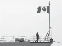  ??   DANIEL MIHAILESCU/AFP/GETTY IMAGES ?? A Canadian soldier stands guard on the HMCS Fredericto­n, docked at Constanta harbour in Romania.