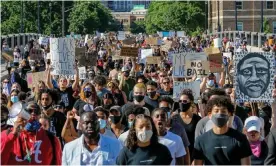  ?? Photograph: Eric Miller/Reuters ?? Thousands of protesters march on Friday from downtown to the site of the arrest of George Floyd in Minneapoli­s.