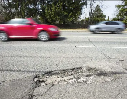  ?? ERNEST DOROSZUK/FILES ?? Believe it or not, municipali­ties often don’t know where potholes are located, writes David Booth.