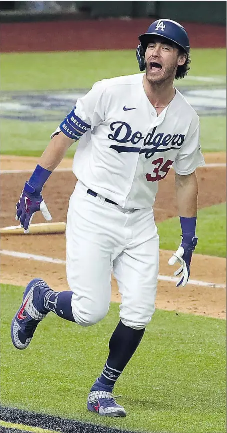  ?? Robert Gauthier Los Angeles Times ?? CODY BELLINGER begins his exuberant home run trot after he whacked an eventual series- clinching shot in Game 7 of the NLCS.