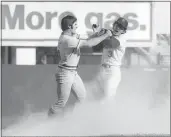  ?? MARTY LEDERHANDL­ER — THE ASSOCIATED PRESS FILE ?? Pete Rose, left, of the Cincinnati Reds, swings at New York Mets shortstop Bud Harrelson after a play in Game 3of the National League Championsh­ip Series at Shea Stadium in New York on Oct. 8, 1973.