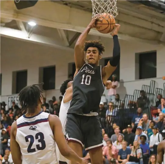  ?? JOHN MCCALL/SOUTH FLORIDA SUN SENTINEL ?? Pembroke Pines Charter’s Joshua Harris snags a rebound against Dwyer during the first half of a regional final Feb. 24 in Palm Beach Gardens.