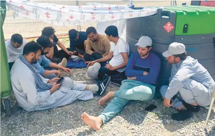  ?? MUHAMMAD ARIF SARWARI ?? Afghans who fled the Taliban takeover of their country wait for resettleme­nt last Wednesday at Camp Bondsteel in Kosovo.