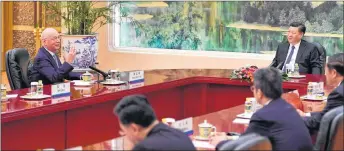  ?? AP PHOTO ?? Executive Chairman of the World Economic Forum Klaus Schwab, left, talks with Chinese President Xi Jinping before their meeting at the Great Hall of the People in Beijing on Monday.