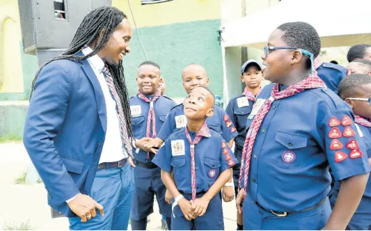  ?? CONTRIBUTE­D ?? Minister of State in the Ministry of Education, Youth and Informatio­n, Alando Terrelonge (left), interacts with Cub Scouts from the Scout Associatio­n of Jamaica at the opening ceremony for the 15th Caribbean Cuboree, held recently at the Ocho Rios High School in St Ann.