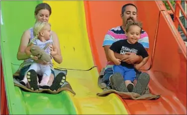  ?? News-herald photos — DEBBY HIGH ?? Alice Fox with her daughter, Jessica, of Harleysvil­le, meet new friends, Sam Levin with son Lucas, of Dublin, on the slide at the Dublin carnival.