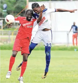  ?? FILE ?? FC Reno’s Omar Johnson (right) in an aerial challenge with Rafick Thomas of Boys’ Town during a Red Stripe Premier League game at the Barbican playing field last season.