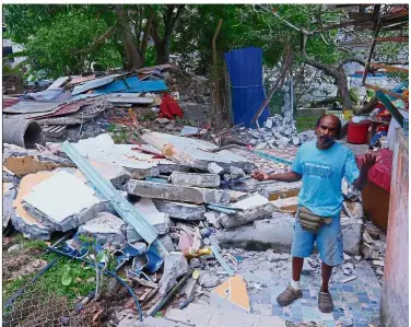  ??  ?? Helpless: James standing among the ruins of his demolished home in Bayan Lepas, Penang.