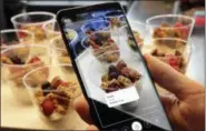  ?? THE ASSOCIATED PRESS FILE ?? The Bixby virtual assistant software of a Samsung Galaxy S9 Plus mobile phone identifies food and displays its calorie content during a product preview in New York.