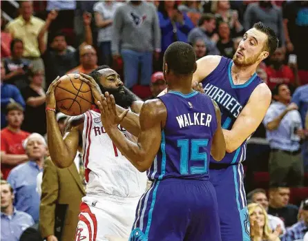  ?? Jon Shapley / Houston Chronicle ?? James Harden faces double the trouble as a result of the defensive efforts of the Hornets’ Kemba Walker, center, and Frank Kaminsky on Tuesday night at Toyota Center. But the Rockets star found enough space during the game to score 40 points.