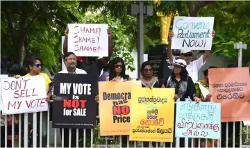  ??  ?? Sri Lankan activists hold placards during a demonstrat­ion in Colombo. — AFP photo