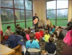  ??  ?? Kristen Abbot reads to the children as part of the Aston Public Library’s Read to Pet Pals Program. The program is set for Thursdays, September 20th to October 11th at 6:30 p.m. Children are divided into small groups for more intimate reading and interactio­n with the pets, and are rotated so that they get a chance to read to a variety of animals.