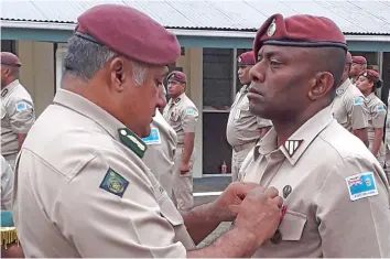  ??  ?? Commission­er of Correction­s Commander Francis Kean awards a medal to one of the 17 correction­s officers at the Naboro Correction­s Complex on December 20, 2018.