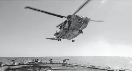  ?? CPL. SIMON ARCAND • CANADIAN ARMED FORCES VIA REUTERS ?? Air detachment members aboard HMCS Fredericto­n attach a fuelling hose on the hoist cable of a CH-148 Cyclone helicopter during Operation Reassuranc­e at sea on Feb. 15, 2020, in this picture obtained from social media.