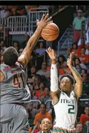  ?? PEDRO PORTAL / EL NUEVO HERALD ?? UM’s Chris Lykes shoots against Steffon Mitchell in the first half. Lykes, a reserve, had 15 points and made all seven of his free throws.