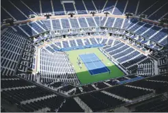  ?? Associated Press photo ?? Players practise at the empty Arthur Ashe Stadium at the U.S. Open tennis tournament on Sunday in New York. The competitio­n starts today.