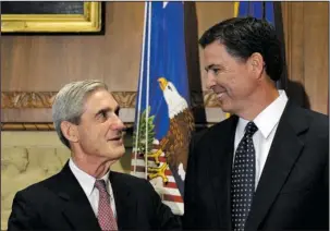  ?? The Associated Press ?? SPECIAL COUNSEL: In this Sept. 4, 2013, photo, then-incoming FBI Director James Comey talks with outgoing FBI Director Robert Mueller before Comey was officially sworn in at the Justice Department in Washington. On Wednesday, the Justice Department...