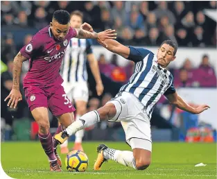  ??  ?? Jake Livermore slides in on Gabriel Jesus to prevent another attack