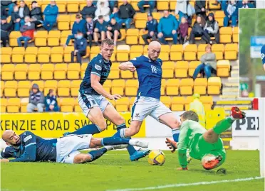  ?? ?? Saints striker Chris Kane slots home his second goal of the match to make it 2-0