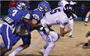  ?? (Pine Bluff Commercial/I.C. Murrell) ?? Grayson Porter of Ashdown fights for extra yardage as J.J. Daniels (3) and Wyatt Jones (54) of DeWitt bring him down in the third quarter of a 4A second-round playoff Friday in DeWitt.