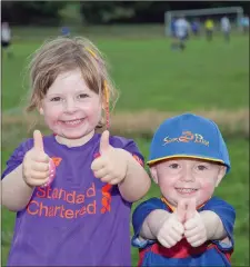  ??  ?? Sadhbh and Patrick Carr giving their dad the thumbs up for the match.