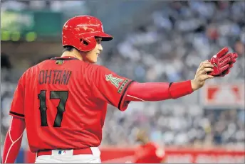  ?? AP PHOTO ?? Los Angeles Angels’ Shohei Ohtani gestures from first base during the third inning of the team’s baseball game against the New York Yankees, Saturday, in New York.